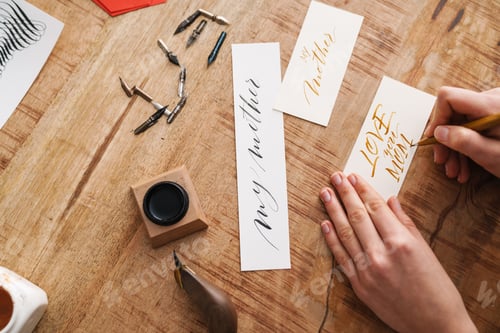 Preview: Calligrapher girl writing while working at table indoors