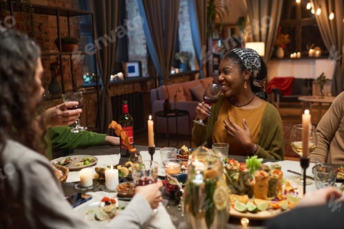 Preview: Woman drinking red wine during a dinner