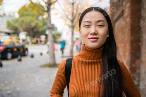 Preview: Portrait of young Asian woman in the street.