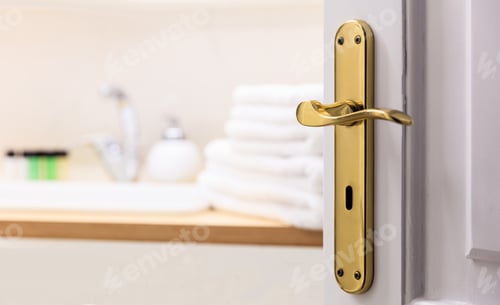 Preview: Bathroom from open door. Blur white towels, soap next to the sink. Close up, blur backdrop, details.