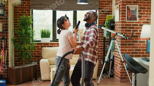Preview: Diverse husband and wife dancing and sweeping floors