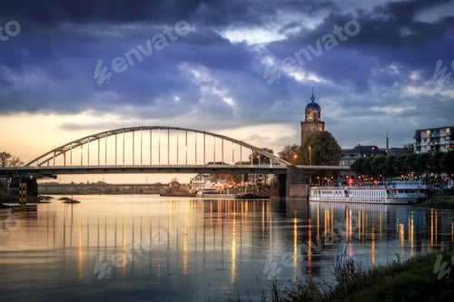 Preview: a river with a bridge, some boats, buildings and grass