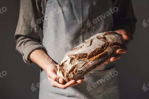 Preview: Baker or chef holding fresh made bread