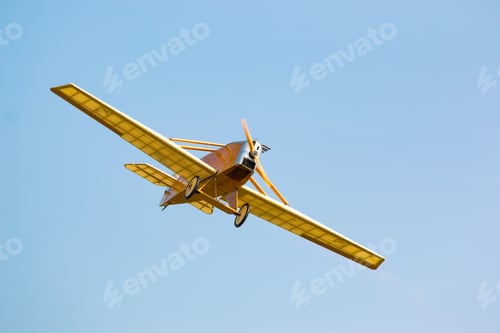 Preview: Vintage yellow plane in blue sky