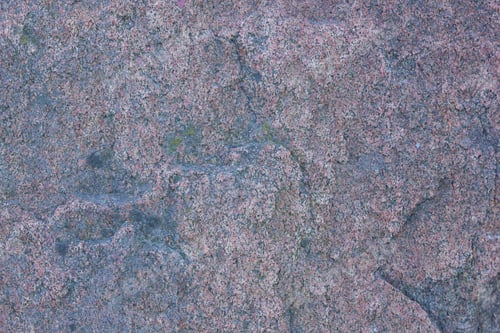 Preview: Texture Of Granite Close Up. Granite Rock With Reddish Color. Background From Solid Stone. Pattern