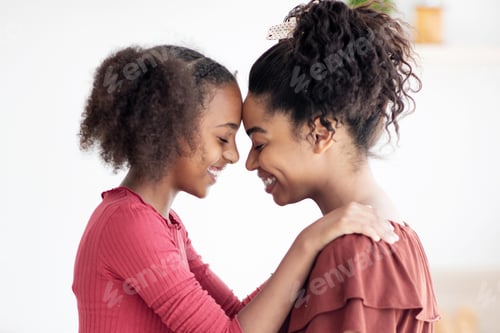 Preview: Profile portrait of happy black mother and daughter