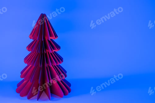Preview: Decorative paper Christmas tree on blue background with trendy neon light.