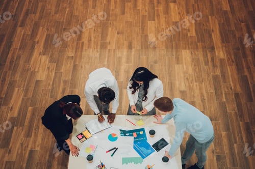 Preview: High angle shot of a multiracial business team having a meeting in office