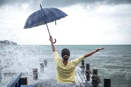 Preview: a young girl on a pier with an umbrella