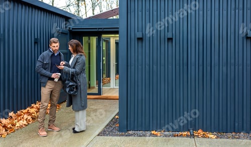Preview: Couple discussing modular home made with shipping containers real estate options using smartphone