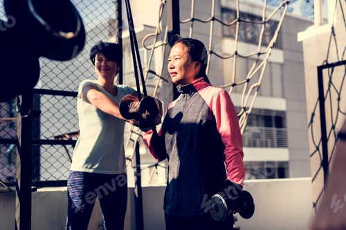 Preview: People exercising at fitness gym