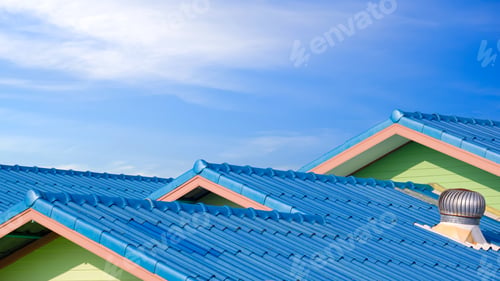 Preview: Blue fiber cement tile roofs in different level with roof ventilator against blue sky background