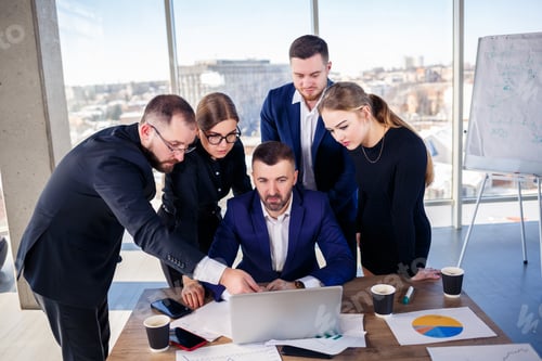 Preview: Business, technology and office concept - happy business team with laptop computers, documents and