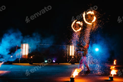 Preview: Fire show, dancing with flame, male master juggling with fireworks, performance outdoors, draws