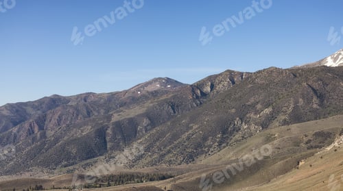 Preview: Dry rocky desert mountain landscape with trees.