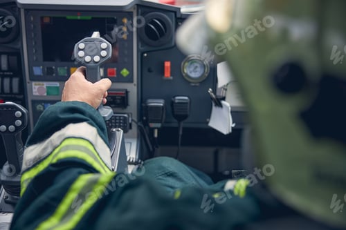 Preview: Man putting arm on the dashboard of truck while managing it