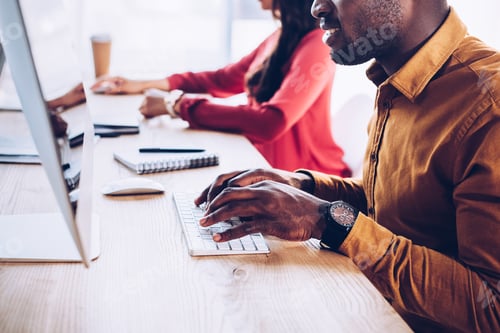Preview: partial view of african american business people working at workplace in office