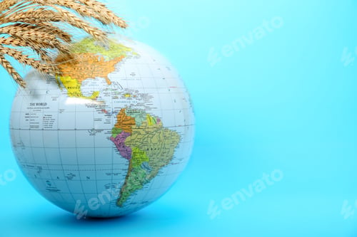 Preview: Globe with wheat spikelets on turquoise background, space for text. Hunger crisis concept