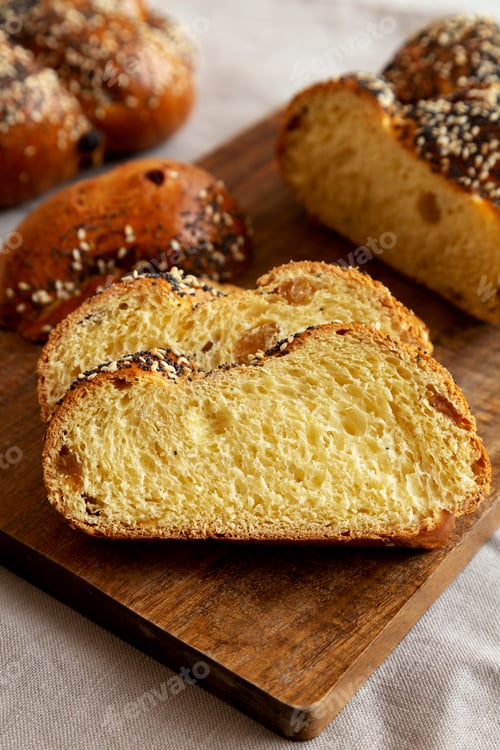 Preview: Homemade Challah Bread covered with Poppy and Sesame Seeds, side view.