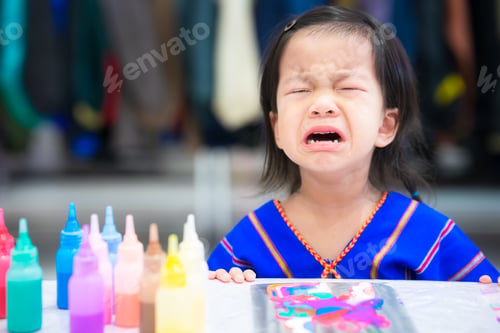 Preview: Girl cries after making a mistake in the art. Cute child sad. Little kid was upset that his artwork.