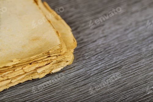 Preview: Opened destroyed blank pages of old book on wood background