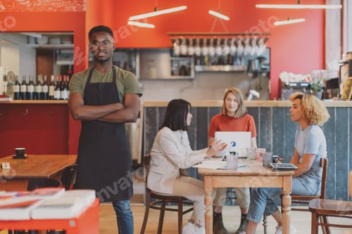 Preview: portrait of a proud African American man in his cafe restaurant