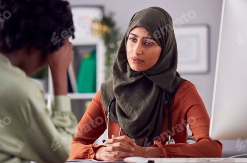 Preview: Female Doctor Or Consultant Wearing Headscarf Having Meeting With Unhappy Female Patient