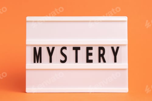Preview: The word mystery on lightbox isolated orange background. Literary Genres