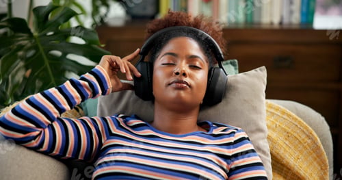Preview: Headphones, relax and woman on sofa listening to music, radio or podcast in living room. Audio tech