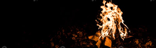 Preview: panoramic shot of flame and logs in camp fire in darkness in the night