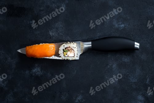 Preview: Different Sushi served on japanese knife on a black slate plate . flat lay