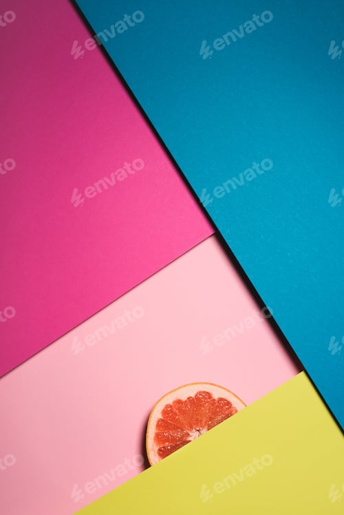 Preview: top view of slice of grapefruit on colorful surfaces