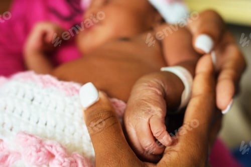 Tiny Infant Hand Held in Gentle Loving Support