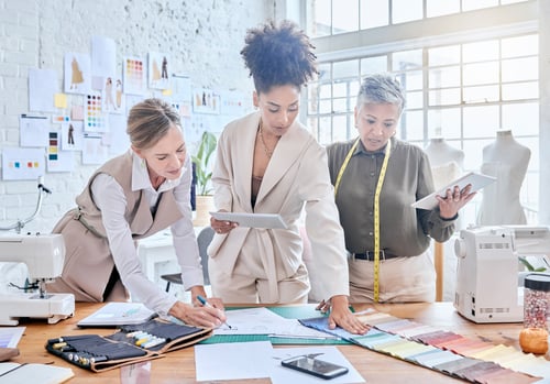 Preview: Planning, fashion and designer with business people in workshop studio for manufacturing, fabric an