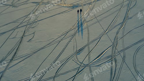 Preview: The upper view on a two explorers going through the snow field.
