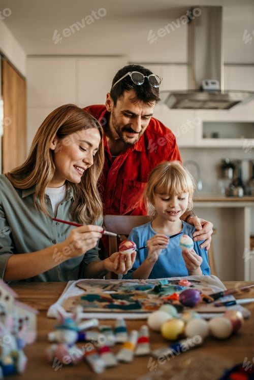 Preview: Family painting easter eggs together at home
