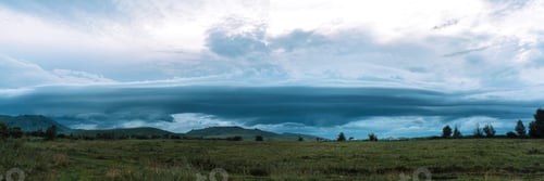 Preview: Dark rain clouds hang over the mountains and village houses
