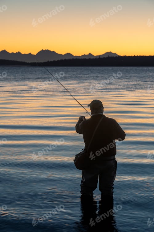 Preview: A fly fisherman gets ready to wade into salt water at sunrise and fly fish for coastal cutthroat