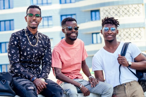 Preview: a group of three fashionable cool African American guys students communicating on the street