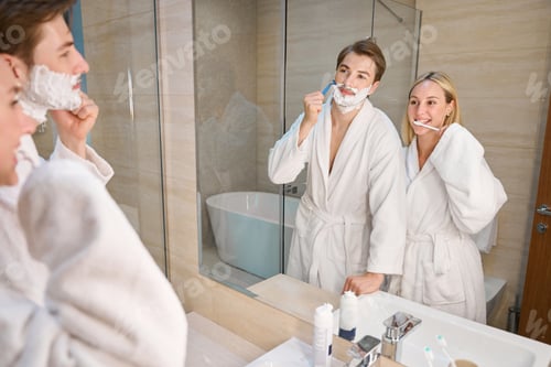 Preview: Blonde woman with boyfriend in bathroom doing morning routine