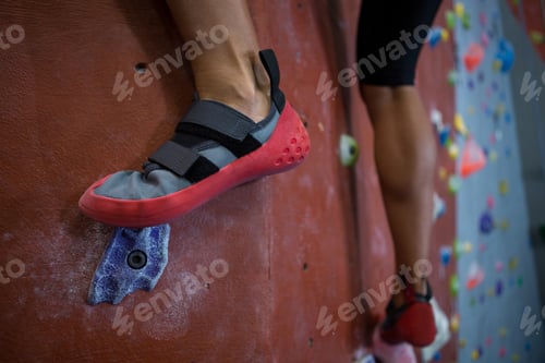 Preview: Woman practicing rock climbing in fitness studio