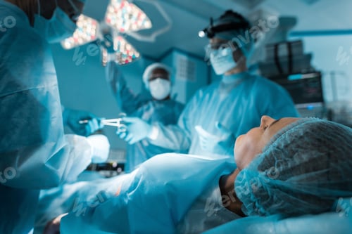 Preview: Surgeons Performing Operation in Brightly Lit Operating Room