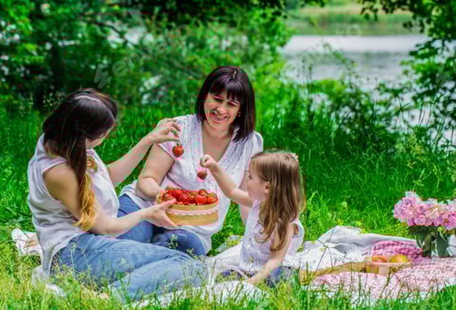 Preview: Women and Child Enjoying Strawberries at Picnic
