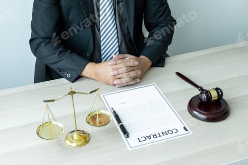 Preview: Male lawyer working with legal case document contract in office