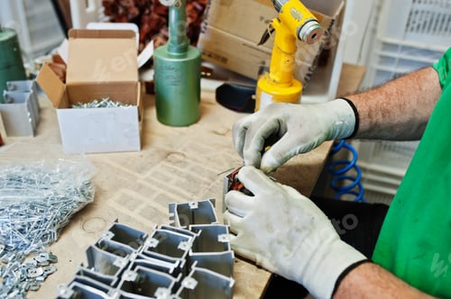 Preview: Man worker hold screwdriver machine and use it.