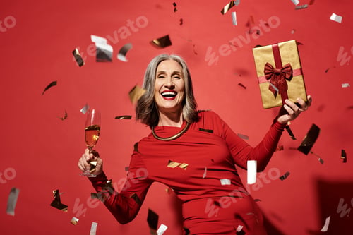 Preview: A joyful celebration of Christmas and New Year with a beautiful mature woman holding gifts