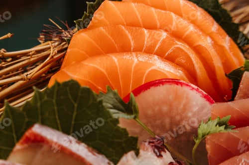 Preview: Close-up of freshly-sliced sushi pieces, near vegetables