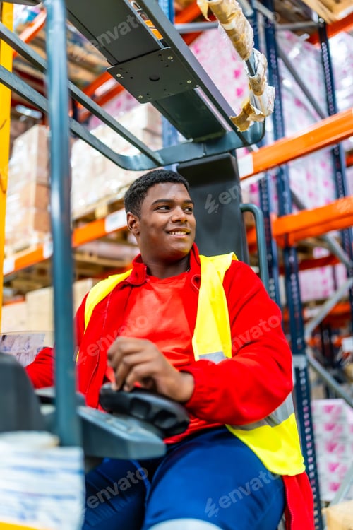 Preview: Happy worker in a forklift working in a storage warehouse