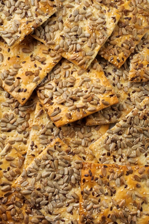 Preview: Abstract background of useful bread with sunflower seeds, flax and sesame seeds. Selective focus. To