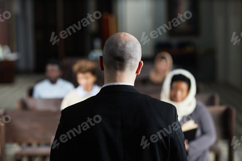 Preview: Pastor talking to believers in church